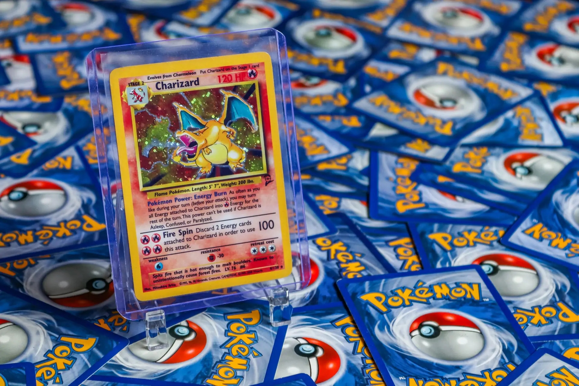 A Pile of Pokemon Trading Cards with a Charizard featured
