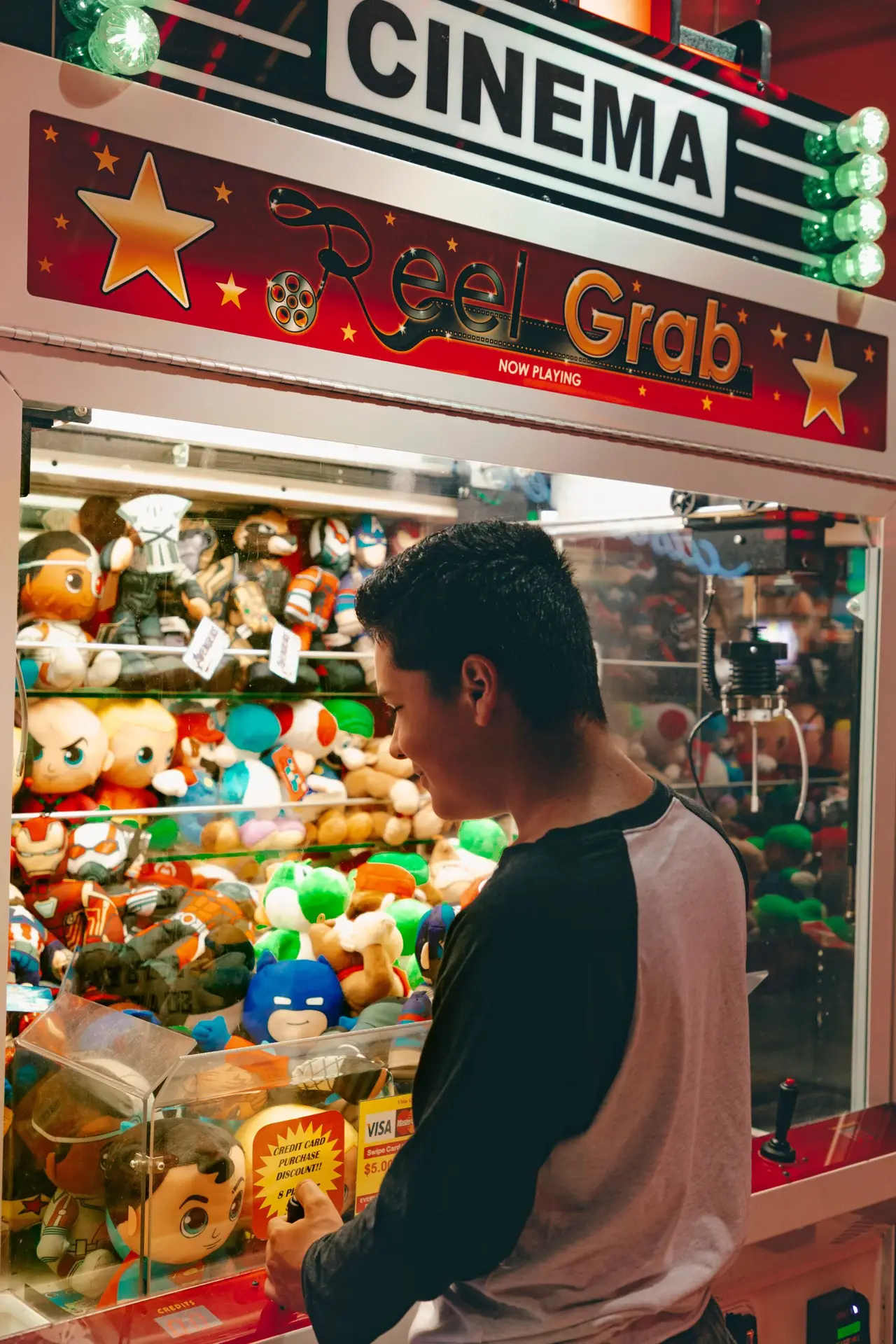 Man playing a claw machine
