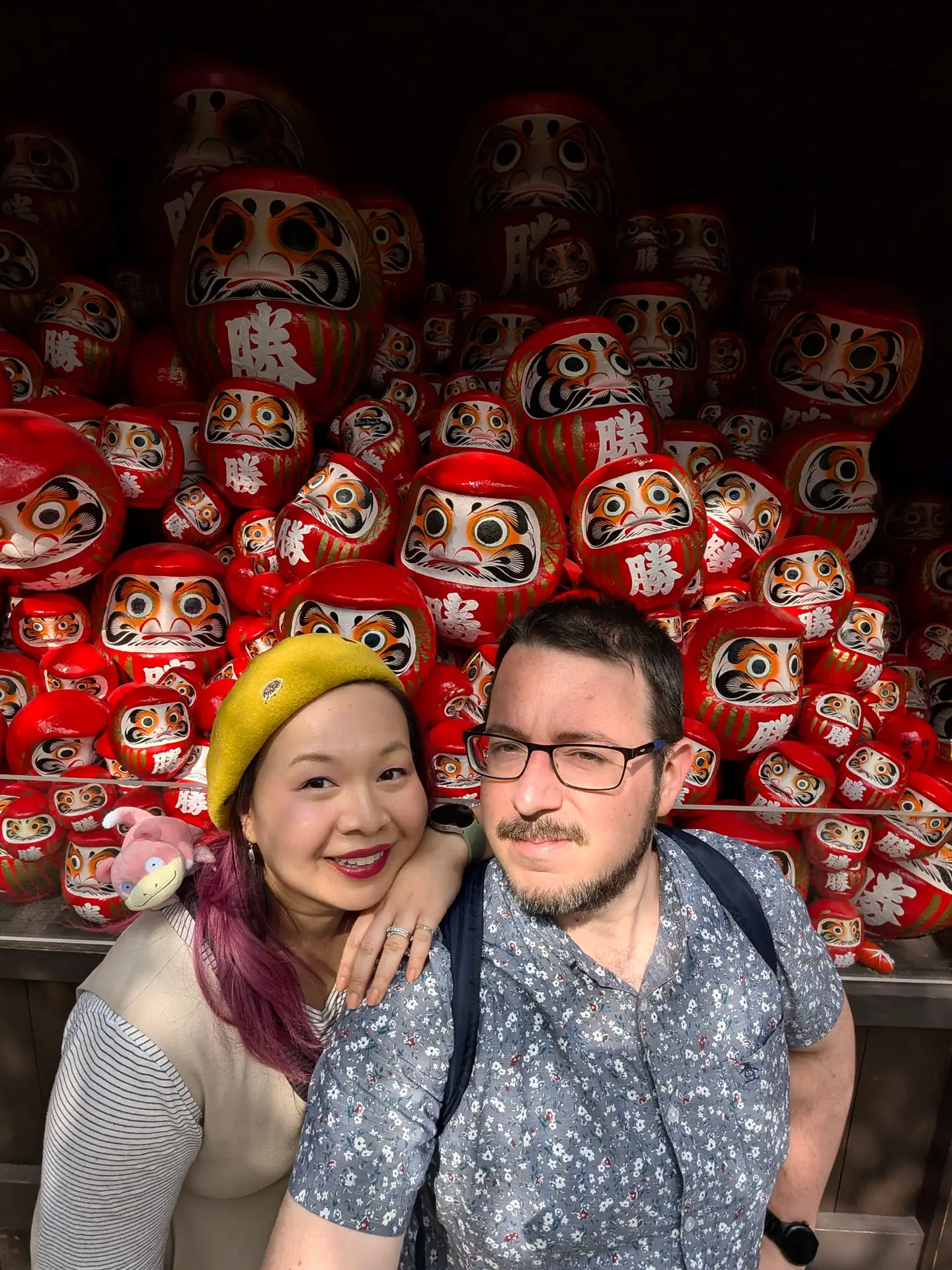 Mitch and Jen surrounded by daruma in Japan